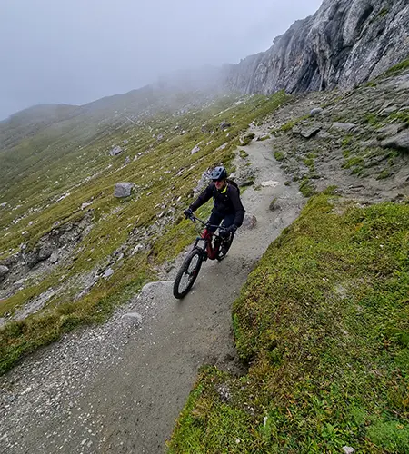 A mountain biker going downhill on single track