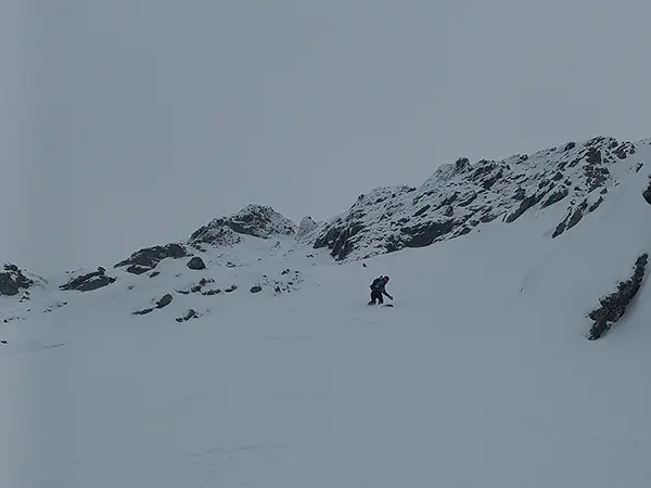 A hiker in the backcountry with skiis